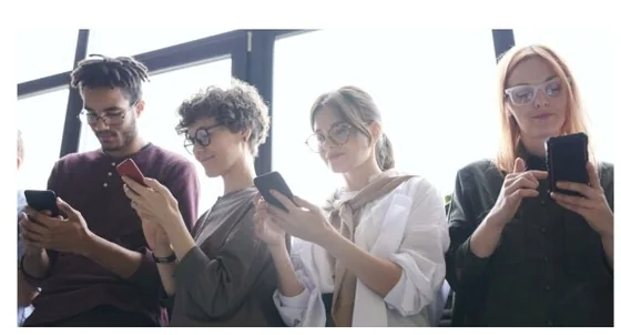 Group of people looking at their phones